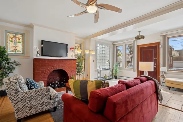 a living room with furniture a flat screen tv and a fireplace