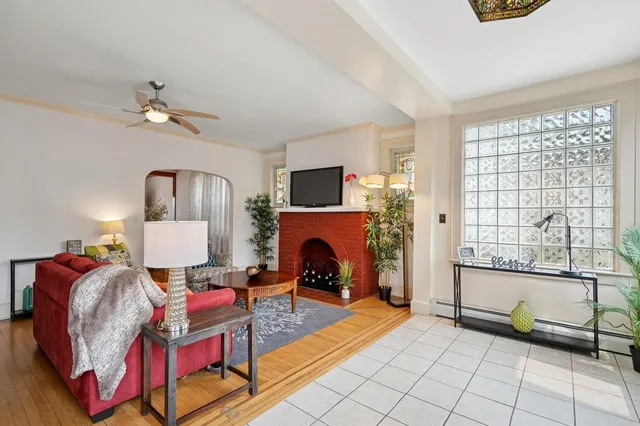 a living room with furniture a fireplace and a flat screen tv