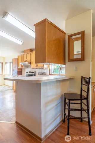 a kitchen with a sink cabinets and a wooden floor
