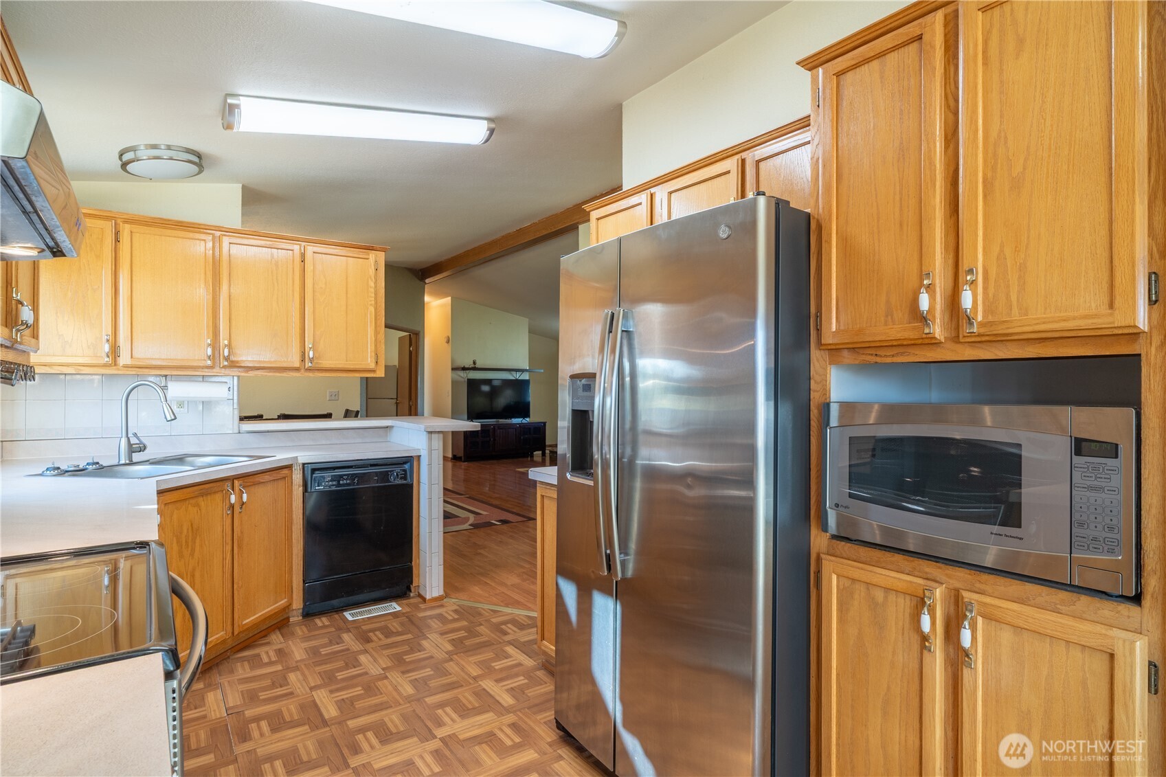 4331 Rd K 2 Street Northeast Moses Lake, WA 98837 - Photo 15 of 38 a kitchen with stainless steel appliances granite countertop a refrigerator a stove and a sink with large window