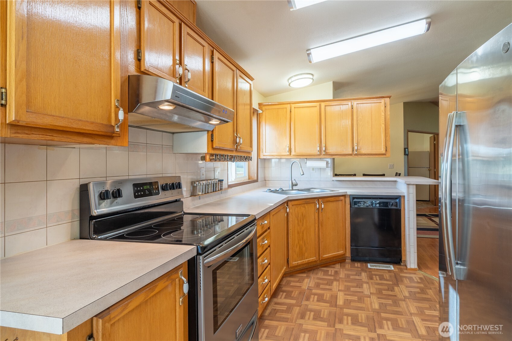 4331 Rd K 2 Street Northeast Moses Lake, WA 98837 - Photo 16 of 38 a kitchen with stainless steel appliances granite countertop a stove a sink and a refrigerator