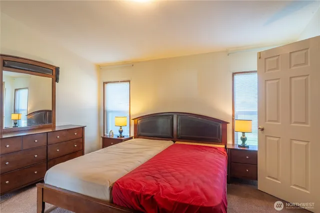 a bedroom with a bed and a dresser