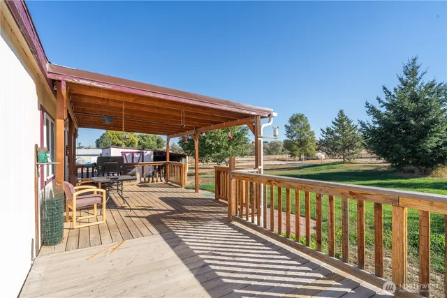 a view of a patio with wooden floor a yard tables and chairs