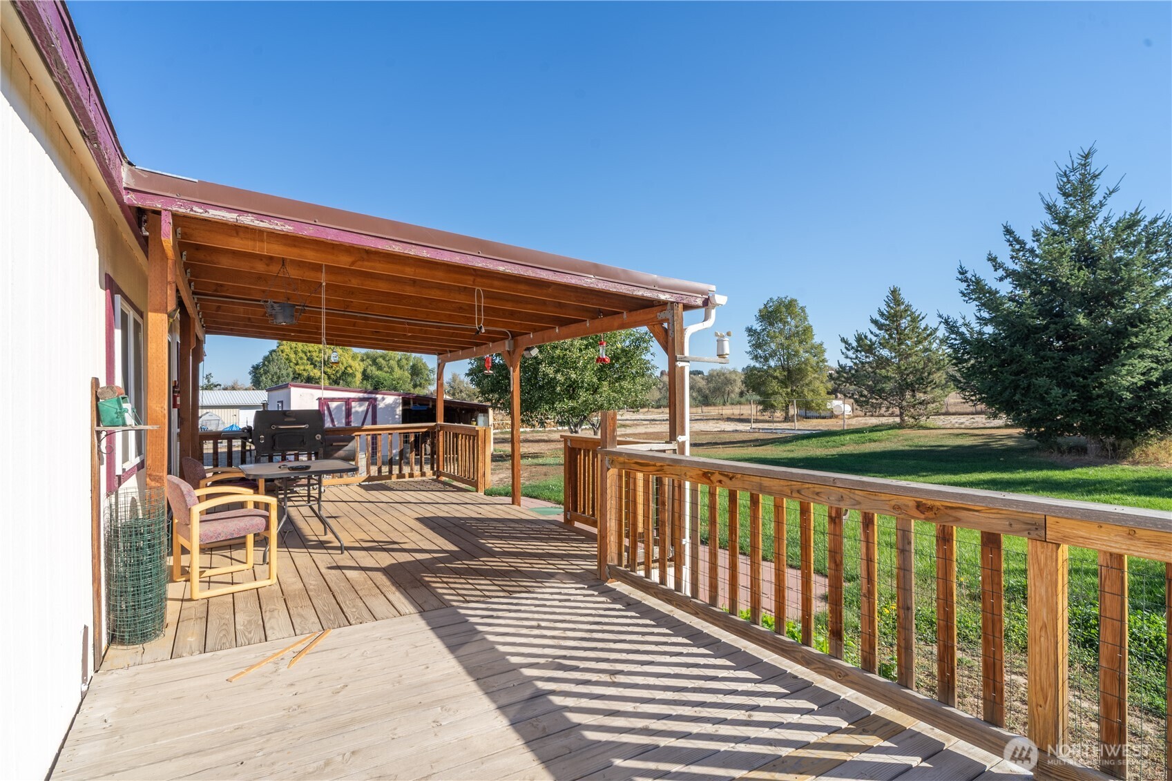 4331 Rd K 2 Street Northeast Moses Lake, WA 98837 - Photo 30 of 38 a view of a patio with wooden floor a yard tables and chairs