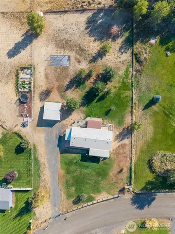 an aerial view of a house with a yard