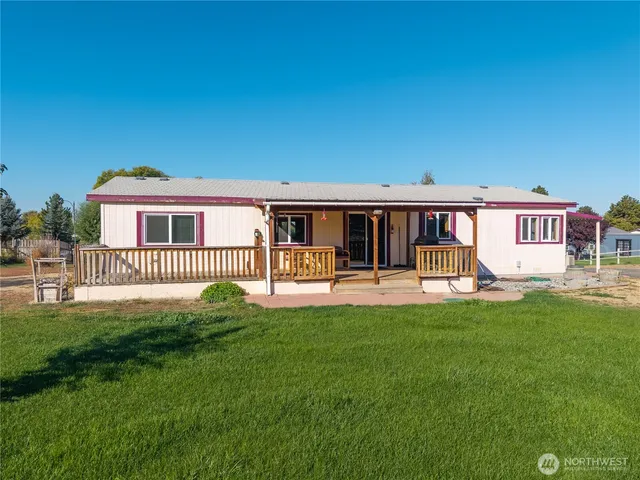 a view of a house with patio and a yard