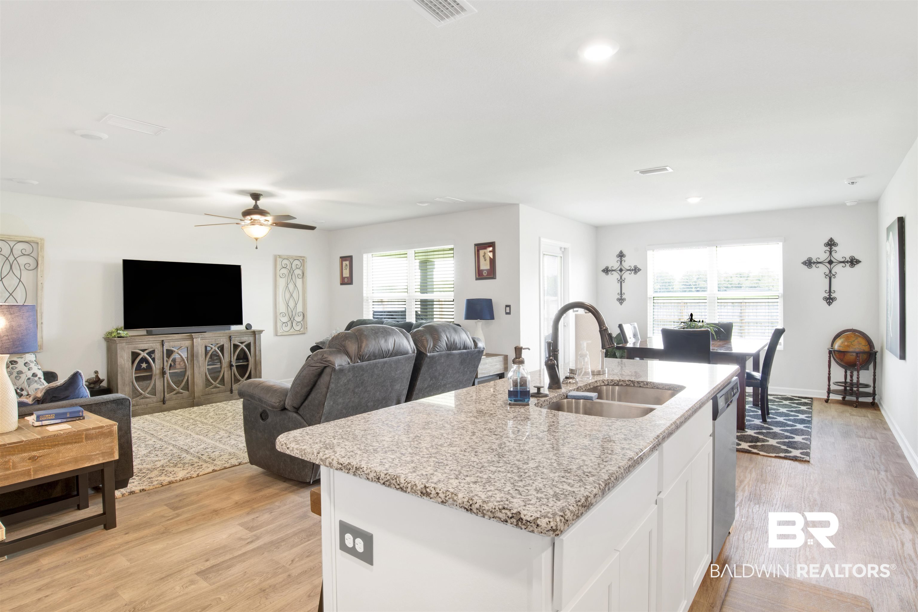 14731 Forsythia Loop Silverhill, AL 36576 - Photo 3 of 25 Kitchen with sink, light hardwood / wood-style flooring, a wealth of natural light, and white cabinets