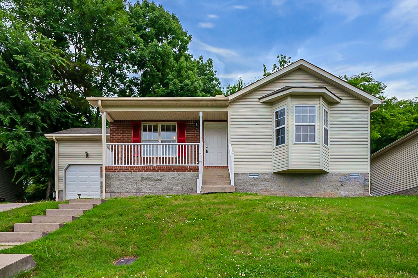 a front view of house with yard and green space