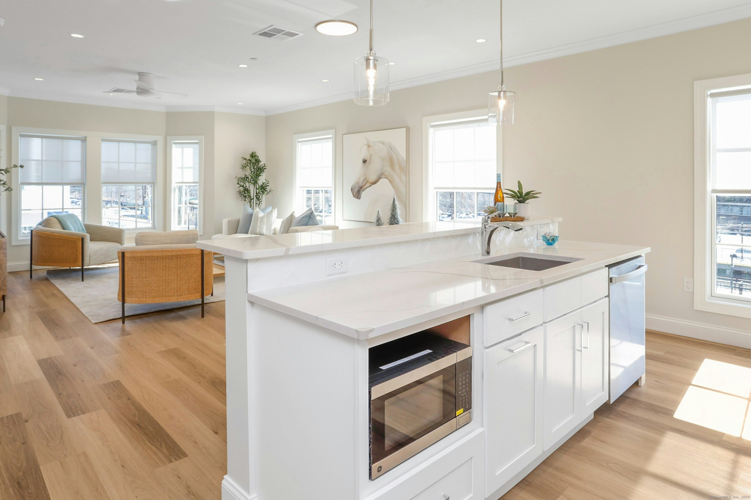 440 Heights Road, Unit 205 Darien, CT 06820 - Photo 4 of 15 a kitchen with stainless steel appliances granite countertop a stove and white cabinets with wooden floor