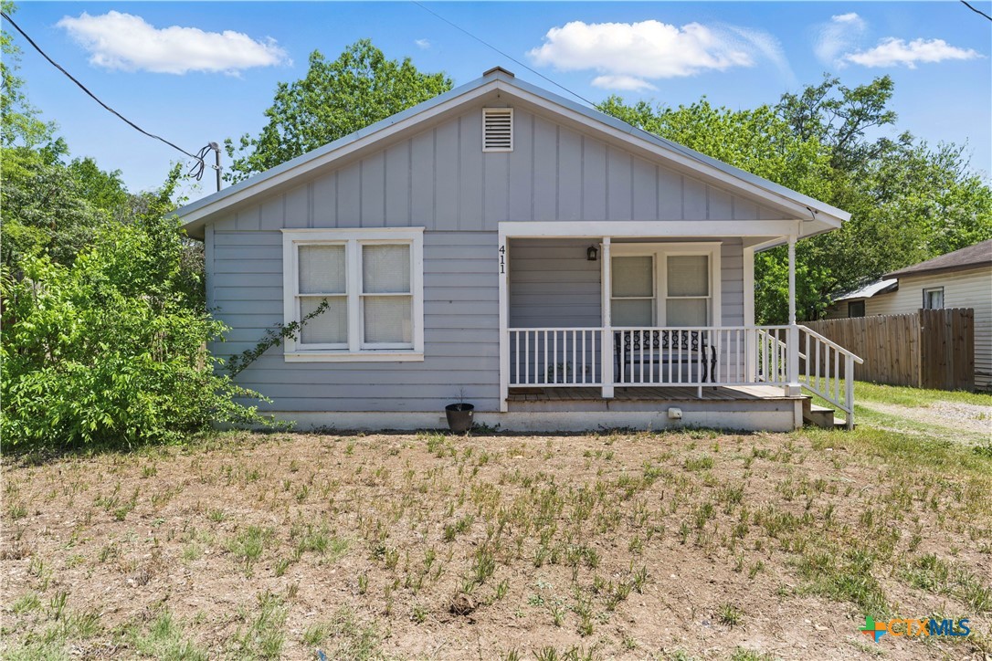 411 Ellis Street Seguin, TX 78155 - Photo 1 of 28 a view of a small house in front of a yard with potted plants