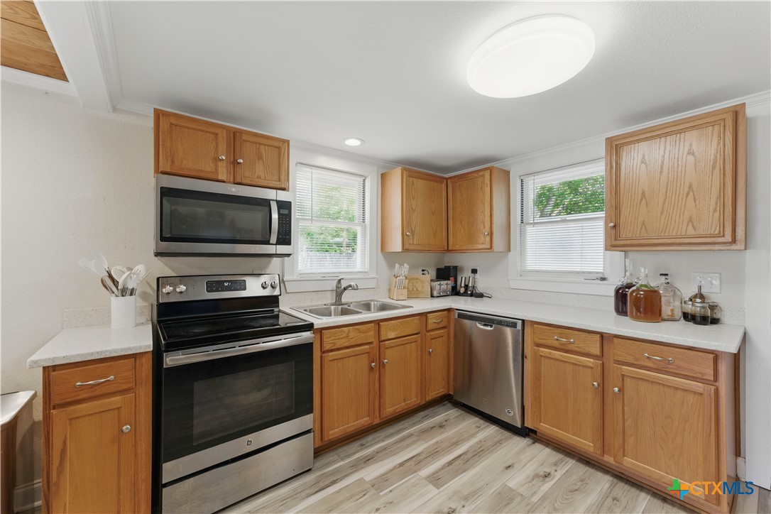 411 Ellis Street Seguin, TX 78155 - Photo 11 of 28 a kitchen with a sink stove and microwave