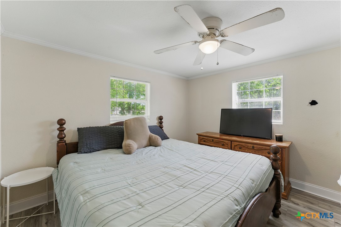 411 Ellis Street Seguin, TX 78155 - Photo 12 of 28 a bedroom with a bed and a flat screen tv