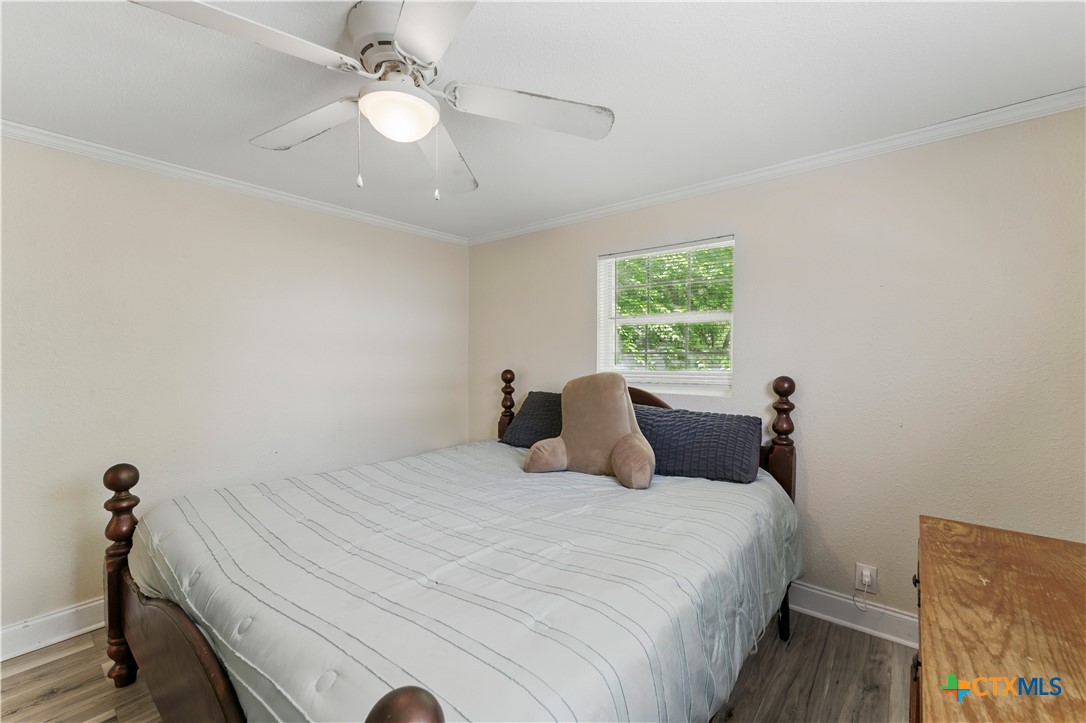 411 Ellis Street Seguin, TX 78155 - Photo 13 of 28 a bedroom with a bed and a chandelier