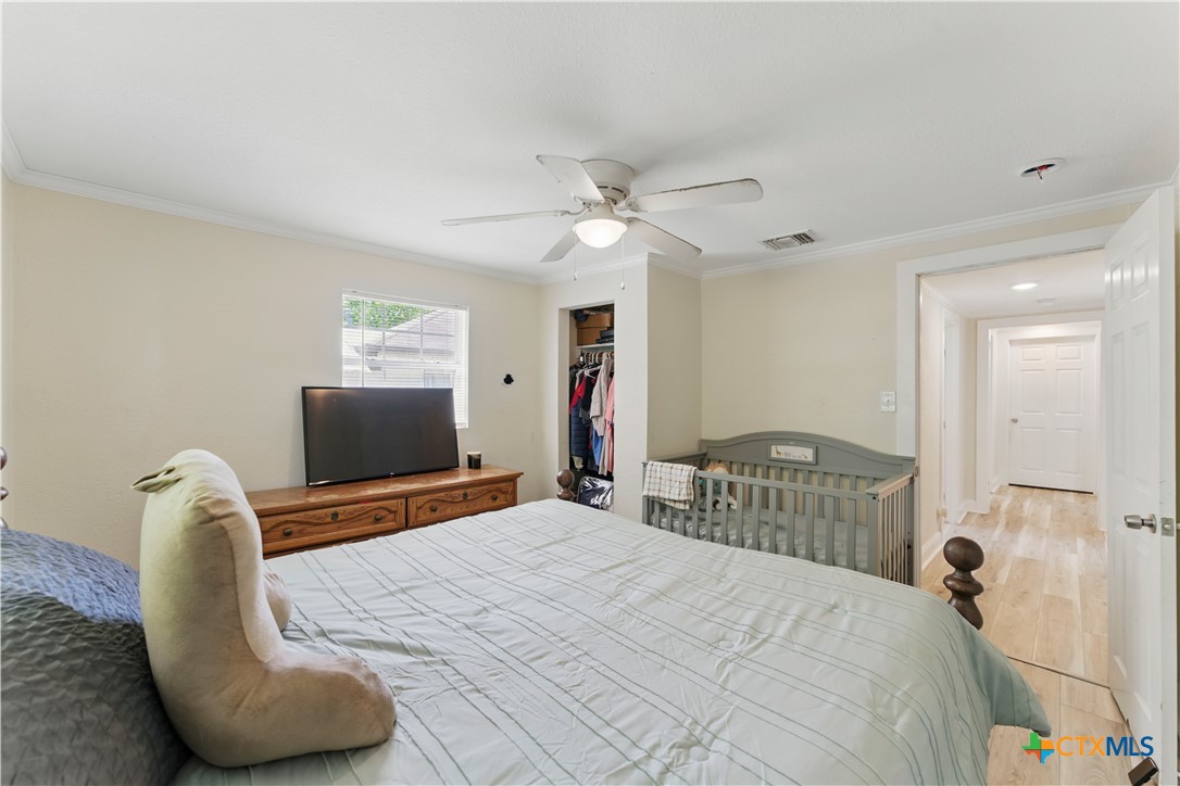 411 Ellis Street Seguin, TX 78155 - Photo 14 of 28 a bedroom with a bed and a chandelier