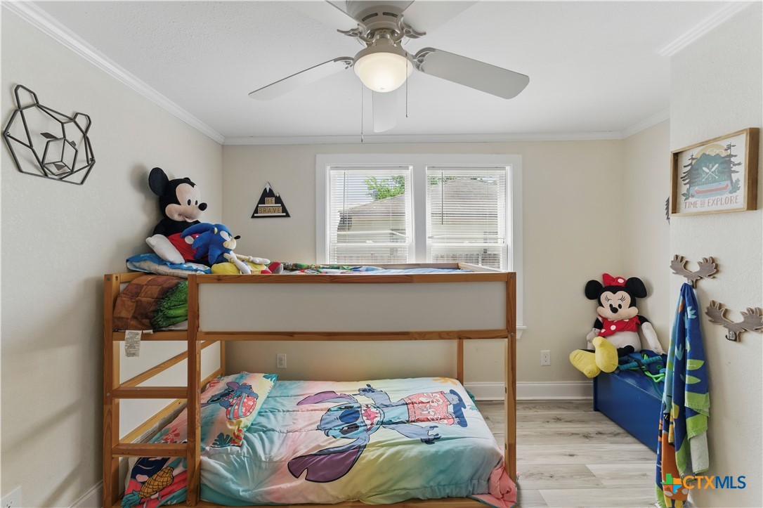 411 Ellis Street Seguin, TX 78155 - Photo 16 of 28 a bedroom with a bed and a chandelier