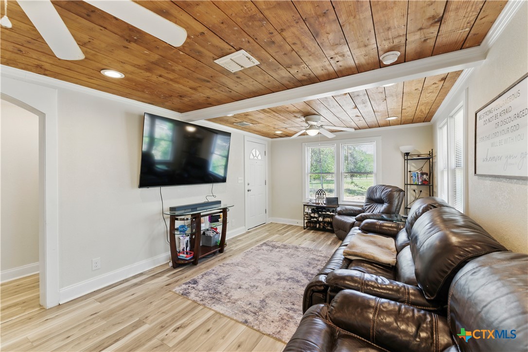 411 Ellis Street Seguin, TX 78155 - Photo 5 of 28 a living room with furniture a flat screen tv and a floor to ceiling window