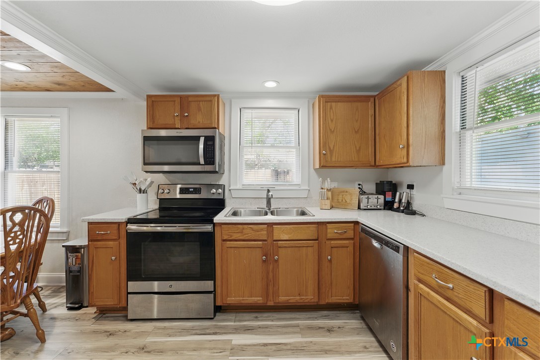 411 Ellis Street Seguin, TX 78155 - Photo 9 of 28 a kitchen with a sink appliances and cabinets