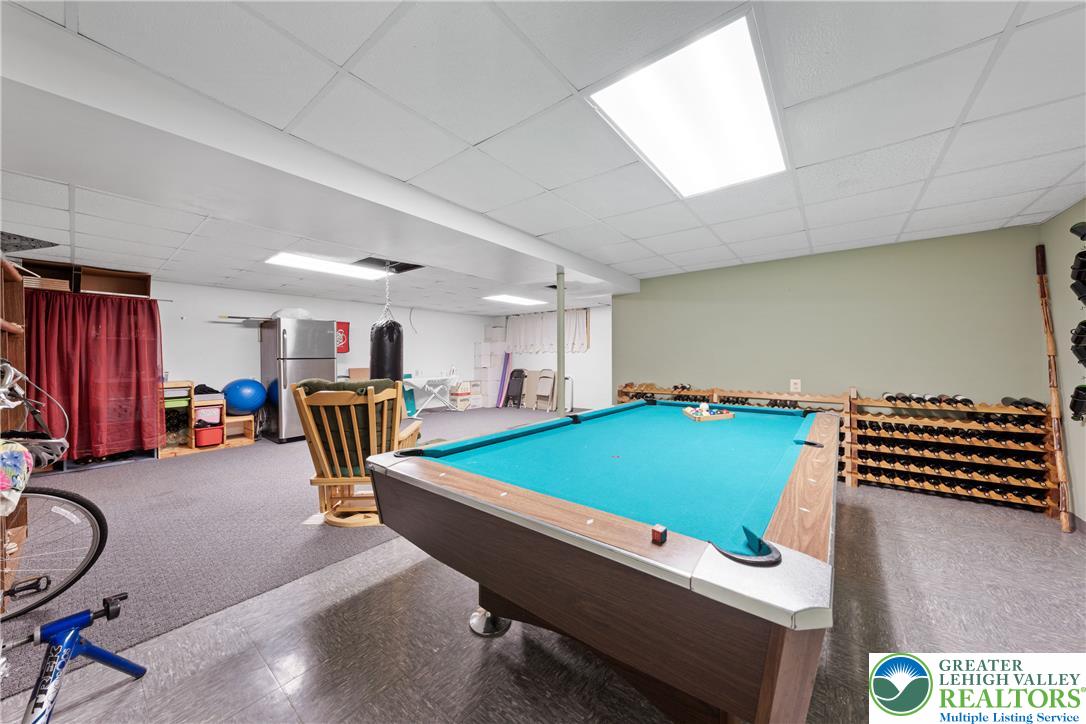 947 Tamenend Road Bath, PA 18014 - Photo 31 of 61 A vibrant billiard table anchors this versatile basement space, perfect for entertainment.