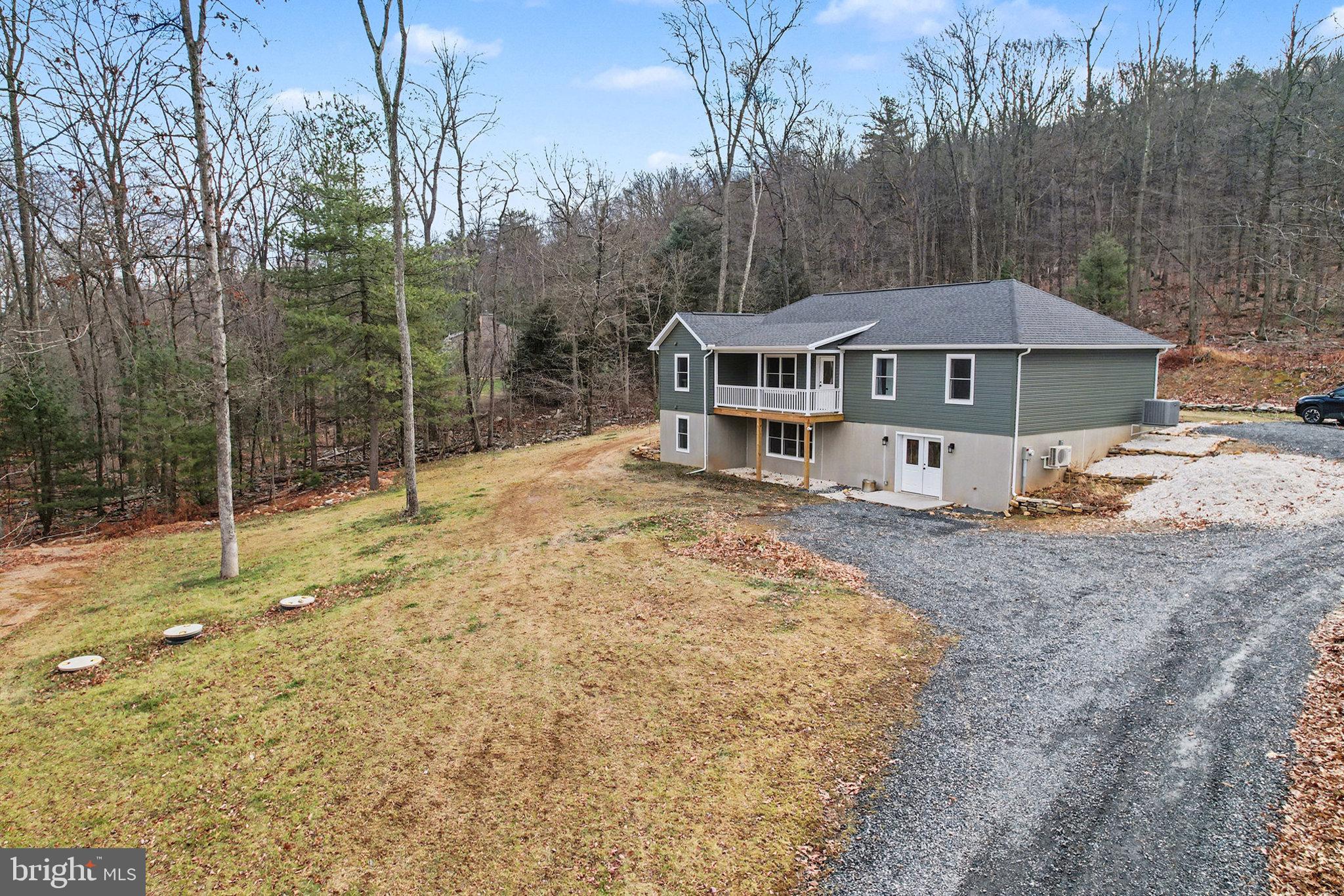a view of a house with backyard and trees