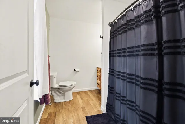 a bathroom with a toilet and a shower