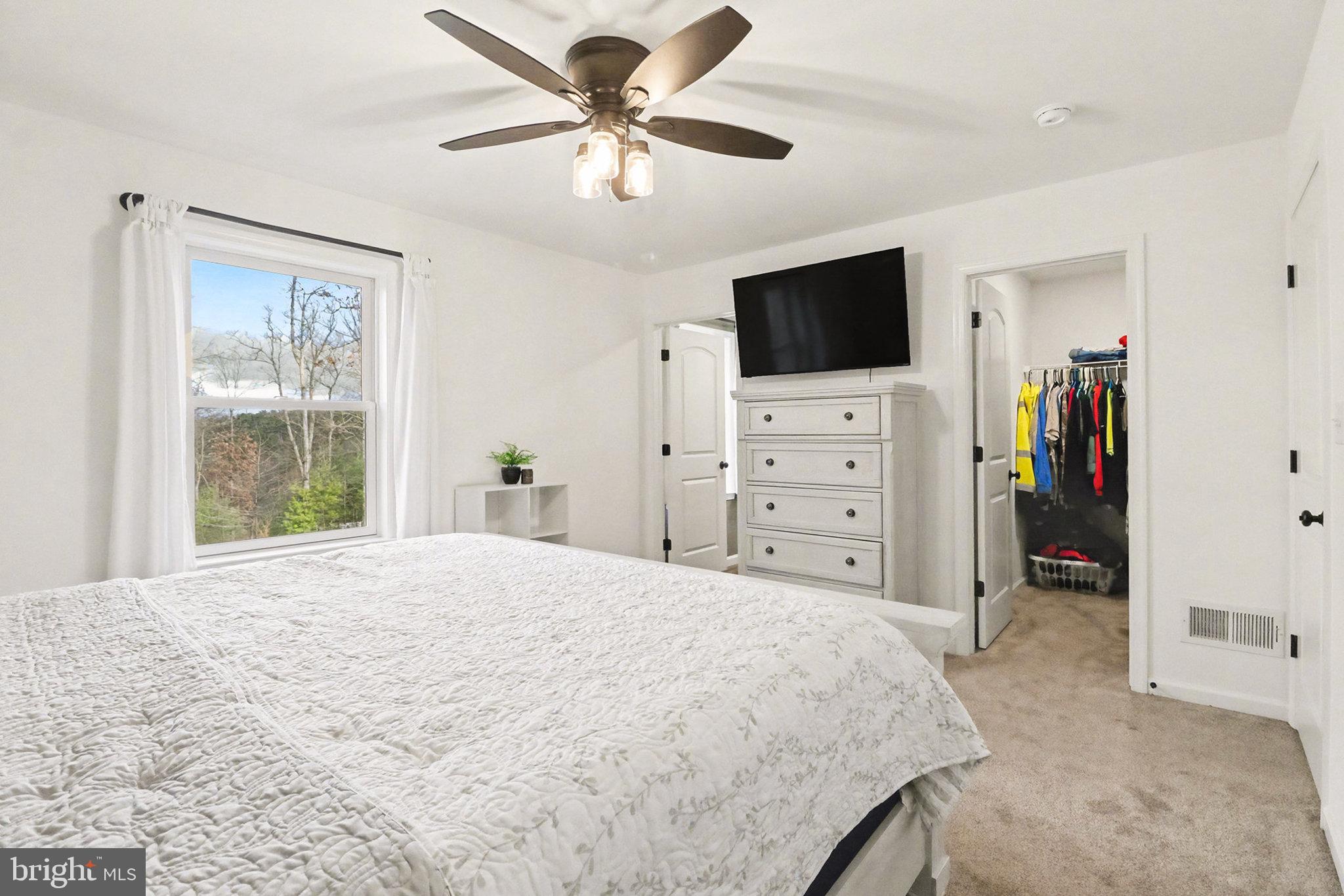1296 Bower Road Shermans Dale, PA 17090 - Photo 21 of 43 a bed room with a bed a television and a large window