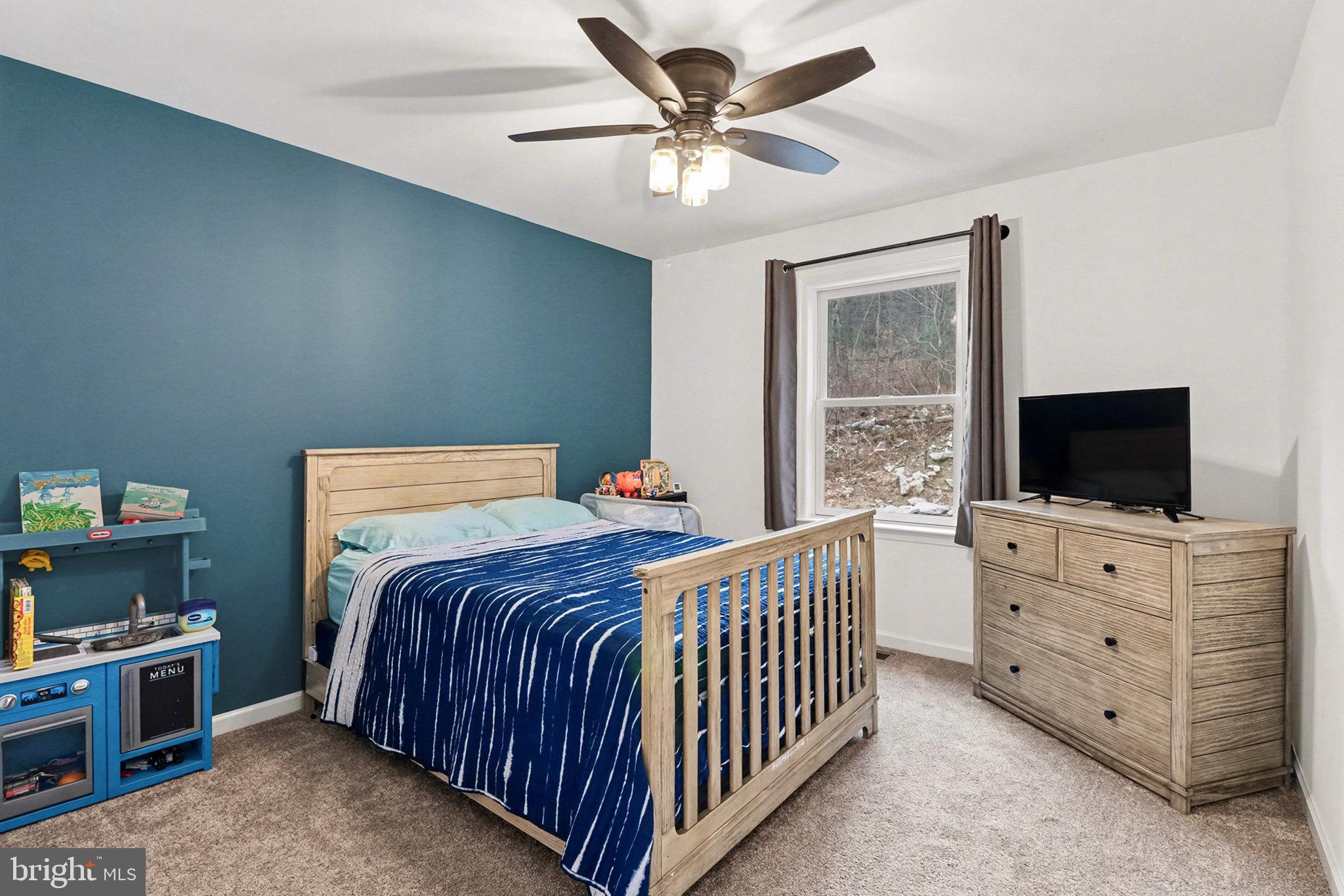 1296 Bower Road Shermans Dale, PA 17090 - Photo 24 of 43 a bedroom with a bed and a flat screen tv in a bedroom