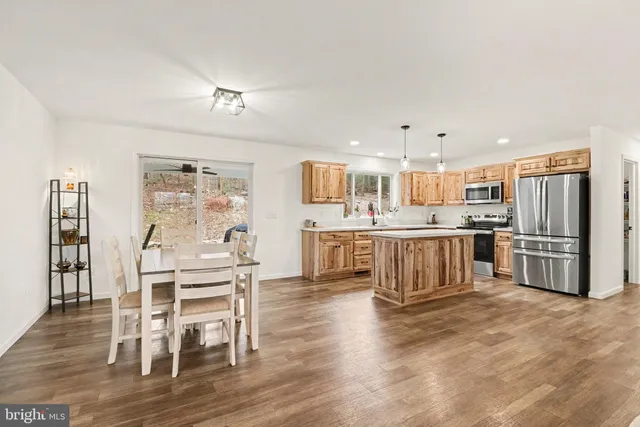 a large kitchen with a table and chairs