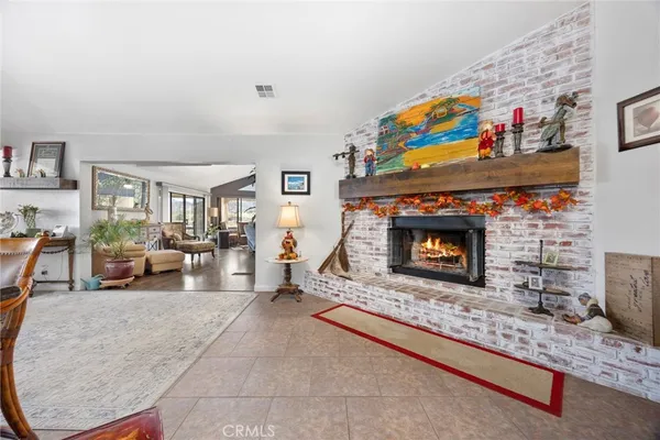 a living room with furniture a flat screen tv and a large window