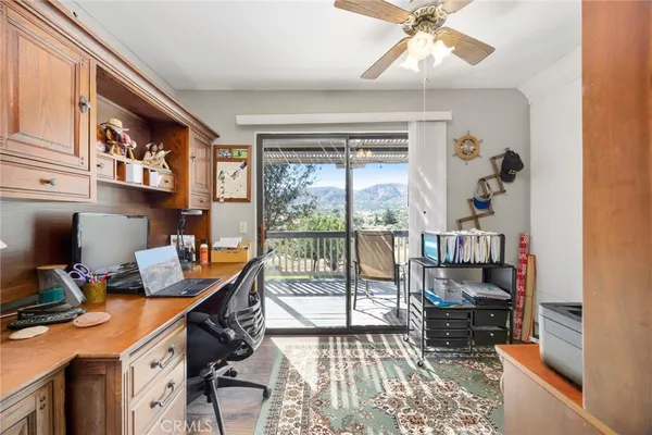 a view of a workspace with furniture and a flat screen tv