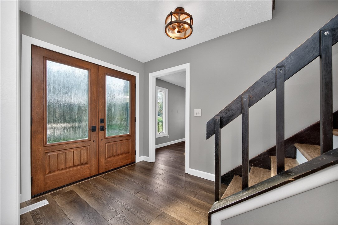 4747 Fawnwood Road Dayton, OH 45429 - Photo 7 of 58 This inviting entryway features rich wooden doors and warm hardwood flooring, leading to a charming staircase.
