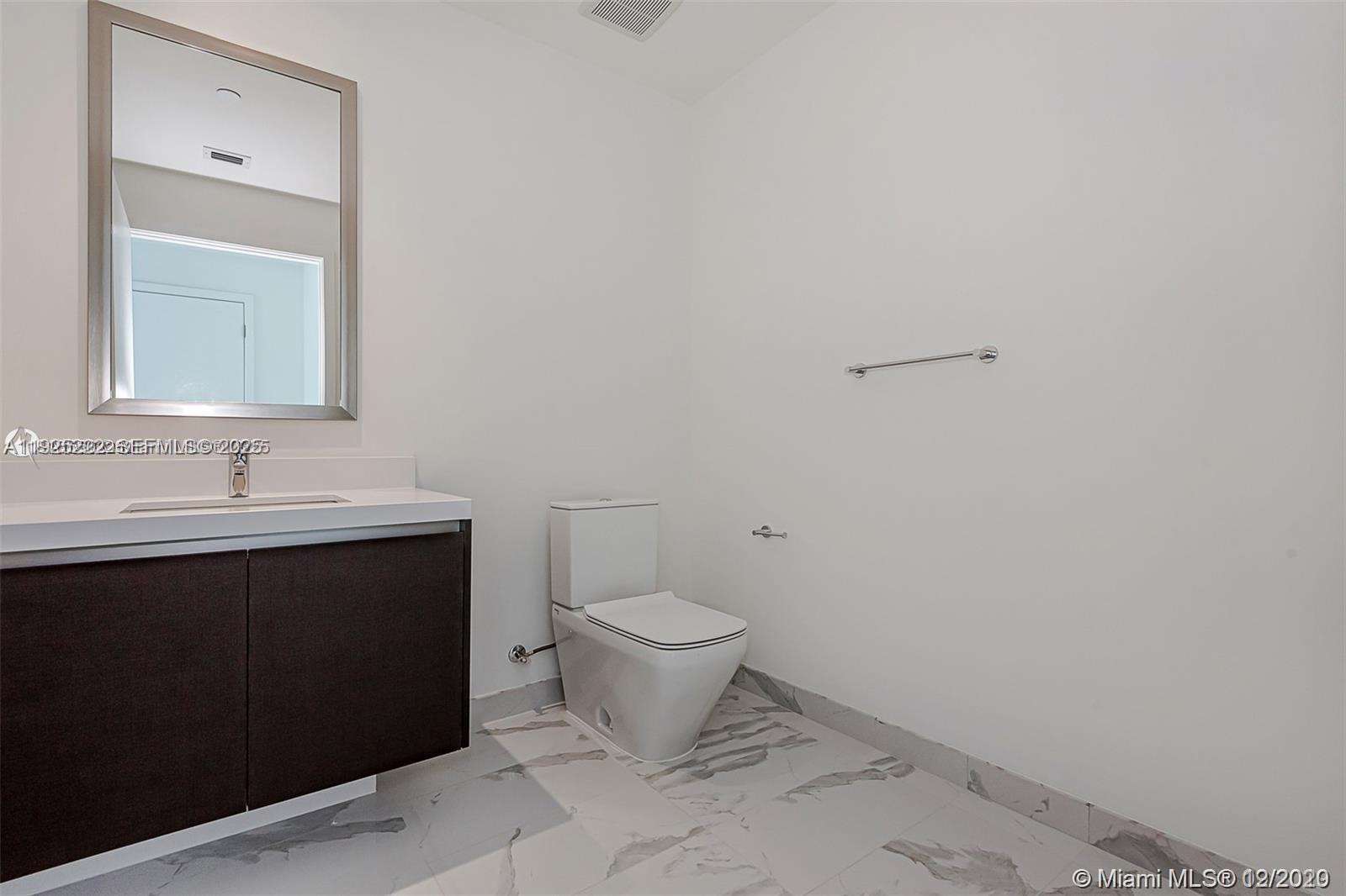 851 Northeast 1st Avenue, Unit 1608 Miami, FL 33132 - Photo 15 of 34 a bathroom with a sink and a toilet