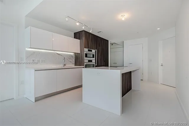 a kitchen with cabinets and white stainless steel appliances