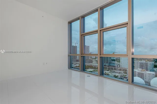an empty room with sliding door and city view