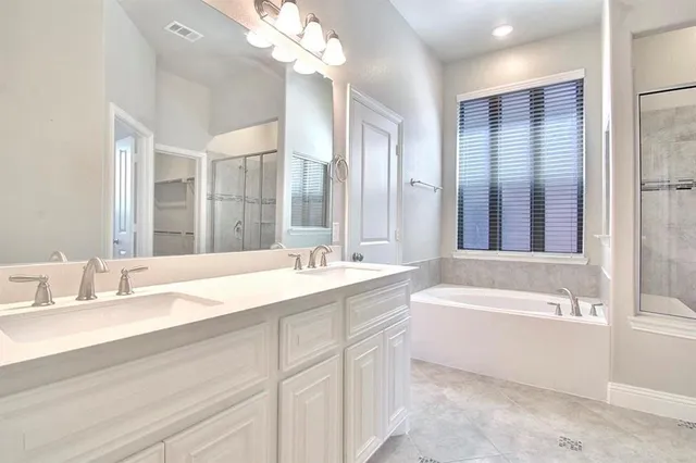 a kitchen with white cabinets and appliances