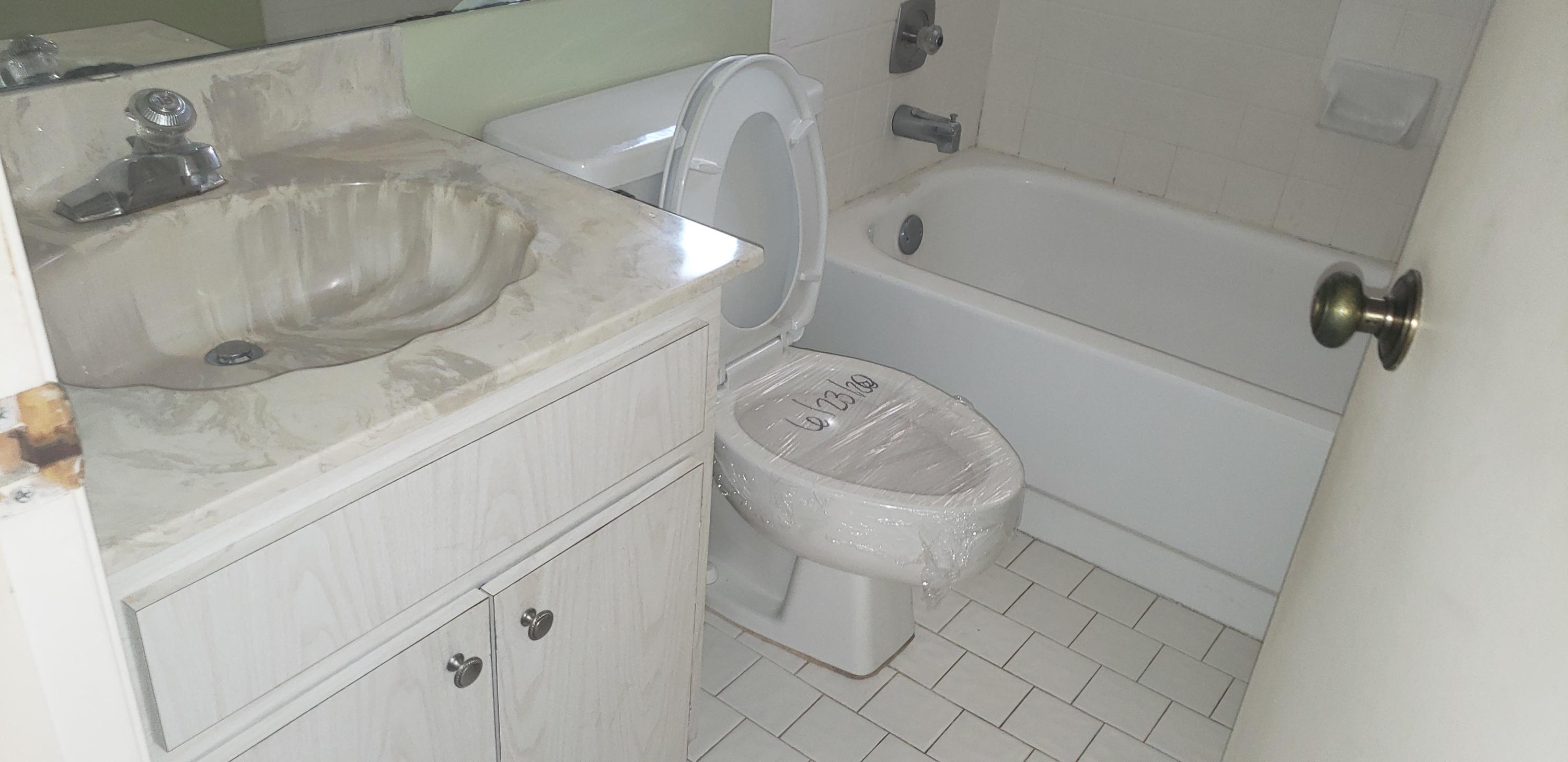 6947 Escobar Court Boca Raton, FL 33433 - Photo 14 of 18 a bathroom with a granite countertop sink toilet and bathtub