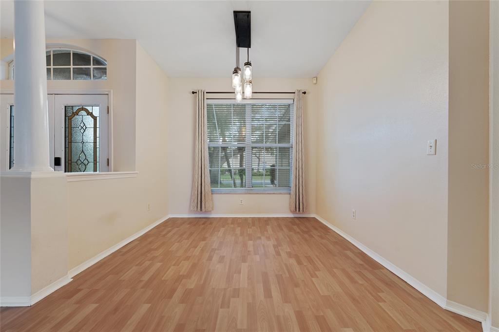 1073 Turtle Lake Court Ocoee, FL 34761 - Photo 22 of 46 a view of an empty room with wooden floor and a window