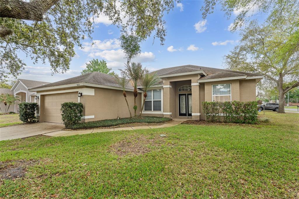 1073 Turtle Lake Court Ocoee, FL 34761 - Photo 3 of 46 a front view of a house with a garden and yard