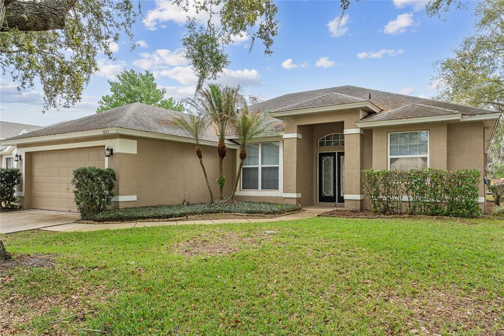 1073 Turtle Lake Court Ocoee, FL 34761 - Photo 5 of 46 a front view of a house with a garden and yard