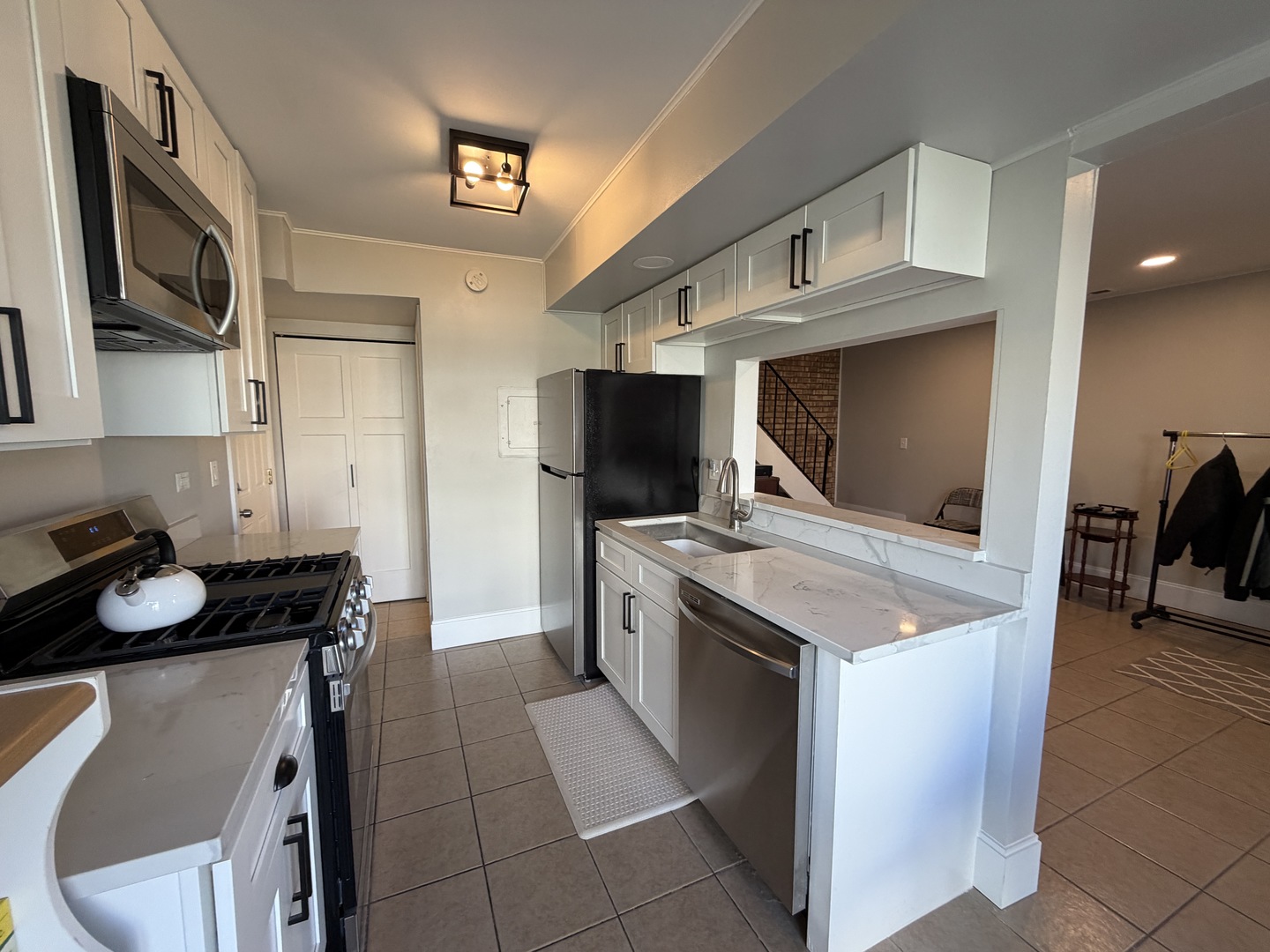 335 David Court, Unit B Bartlett, IL 60103 - Photo 4 of 16 a kitchen with a sink stove and microwave