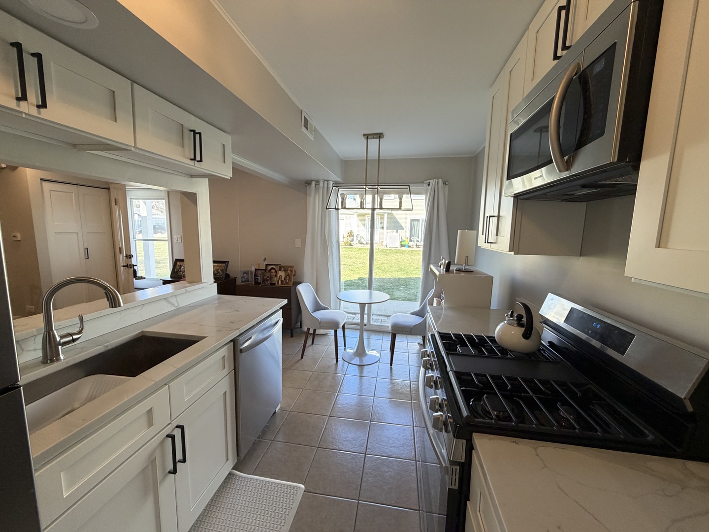335 David Court, Unit B Bartlett, IL 60103 - Photo 7 of 16 a kitchen with stainless steel appliances granite countertop a sink stove and cabinets