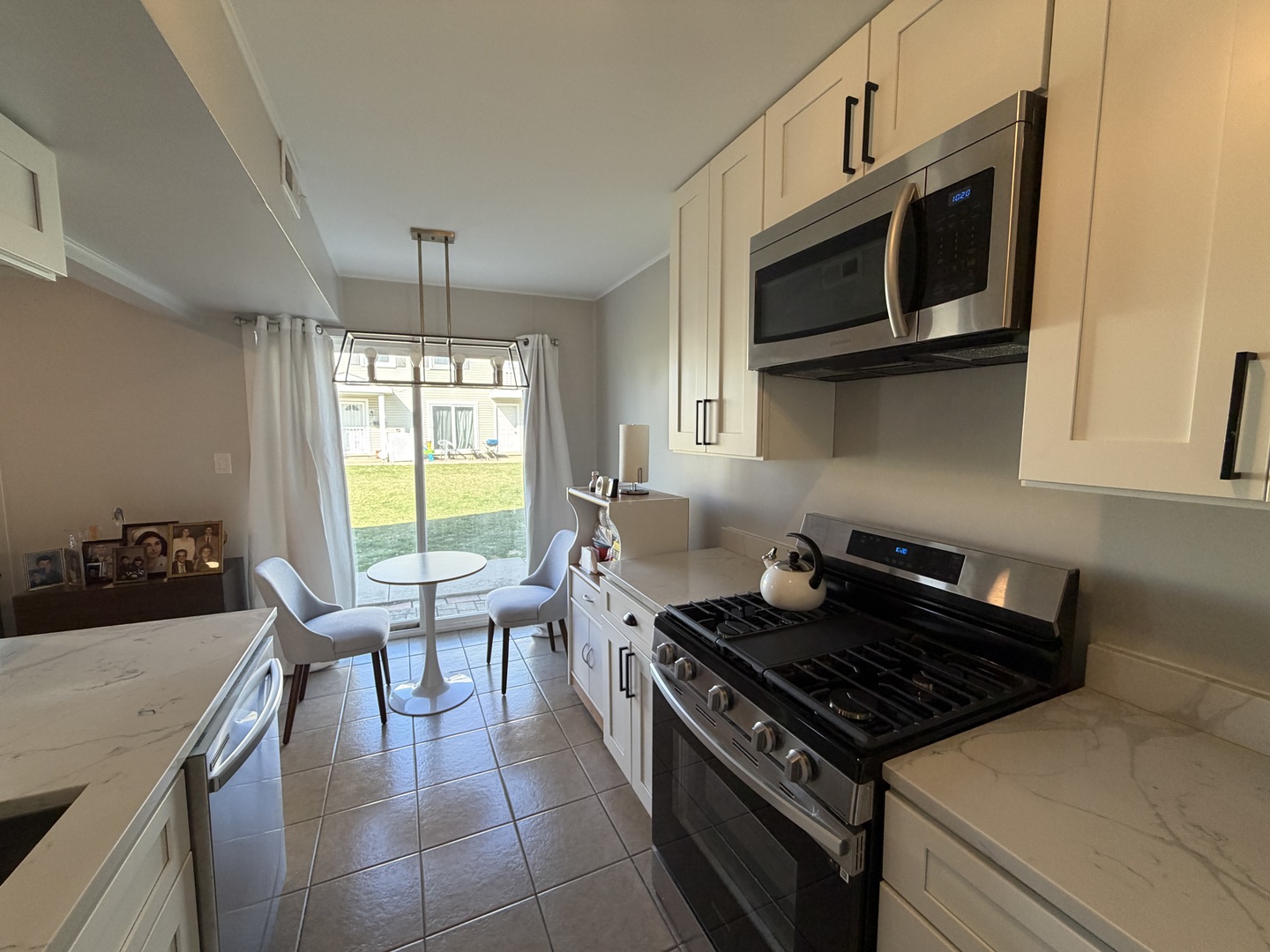 335 David Court, Unit B Bartlett, IL 60103 - Photo 8 of 16 a kitchen with a stove and a microwave