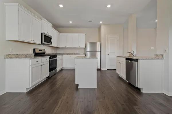 a kitchen with stainless steel appliances a refrigerator sink and cabinets