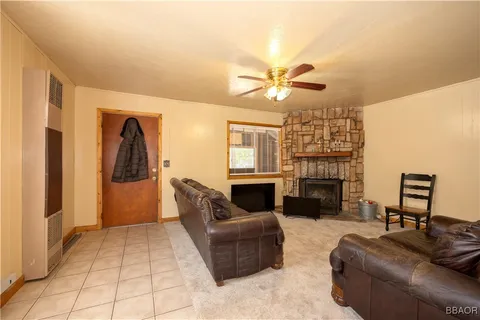 a living room with furniture a fireplace and a chandelier