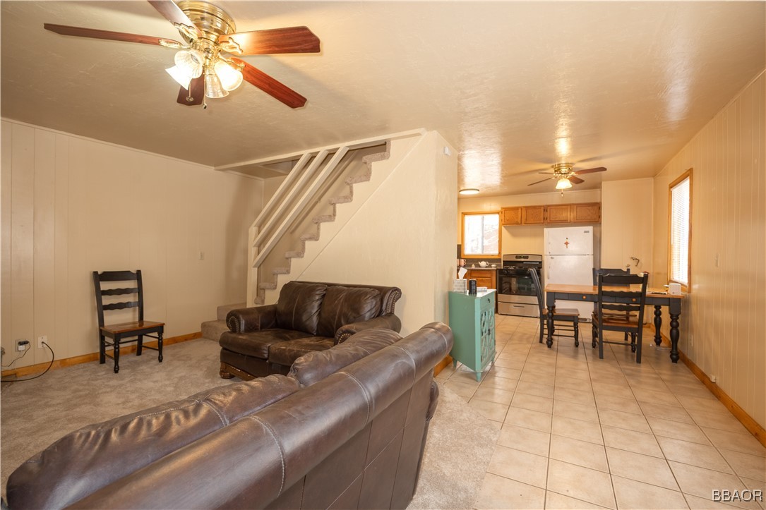 809 San Bernardino Avenue Sugarloaf, CA 92386 - Photo 4 of 23 a living room with furniture and a dining table with wooden floor