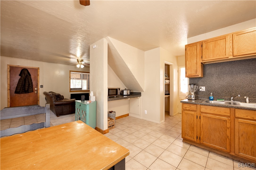 809 San Bernardino Avenue Sugarloaf, CA 92386 - Photo 5 of 23 a kitchen with a sink and cabinets