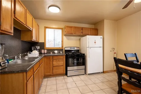 a kitchen with a refrigerator and a stove top oven