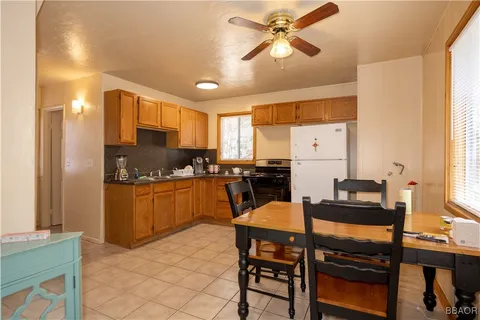 a kitchen with a table chairs refrigerator and cabinets
