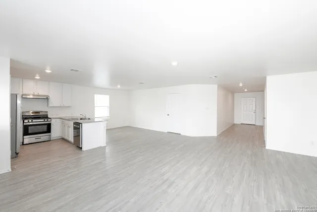 a view of a kitchen with a sink and a stove top oven