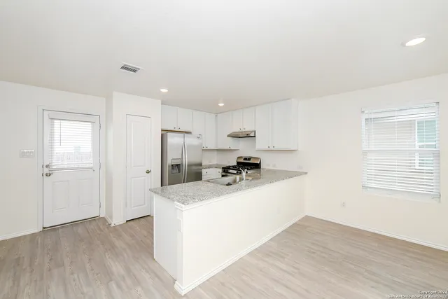 a kitchen with a sink a stove and a refrigerator
