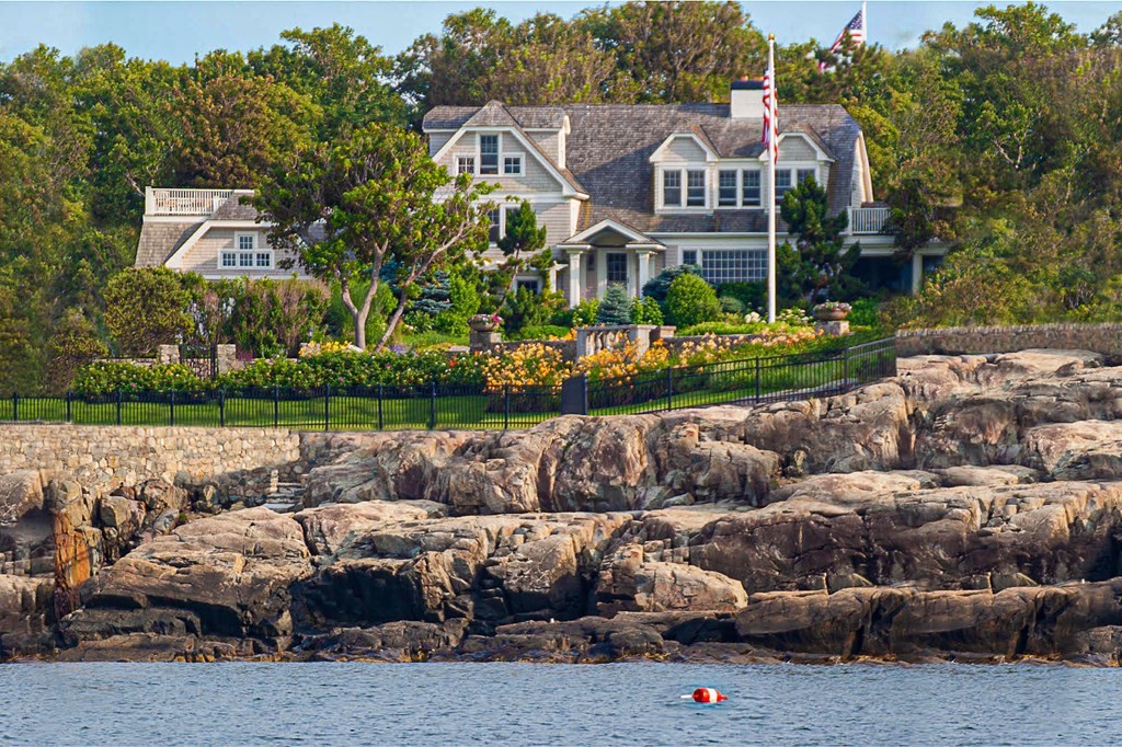 a view of a white house with a big yard and large trees
